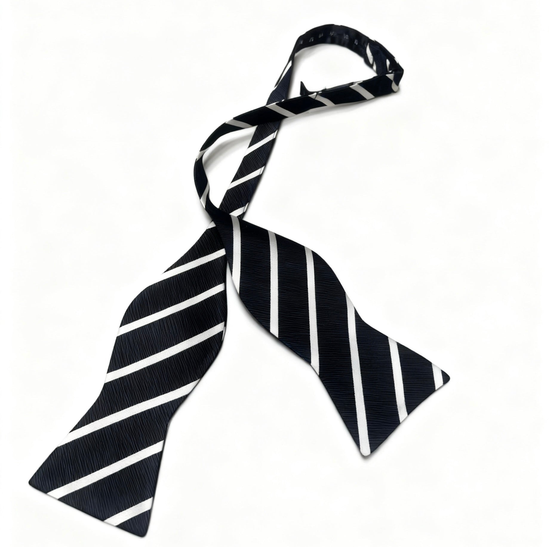 Black and white striped bow tie on a white background