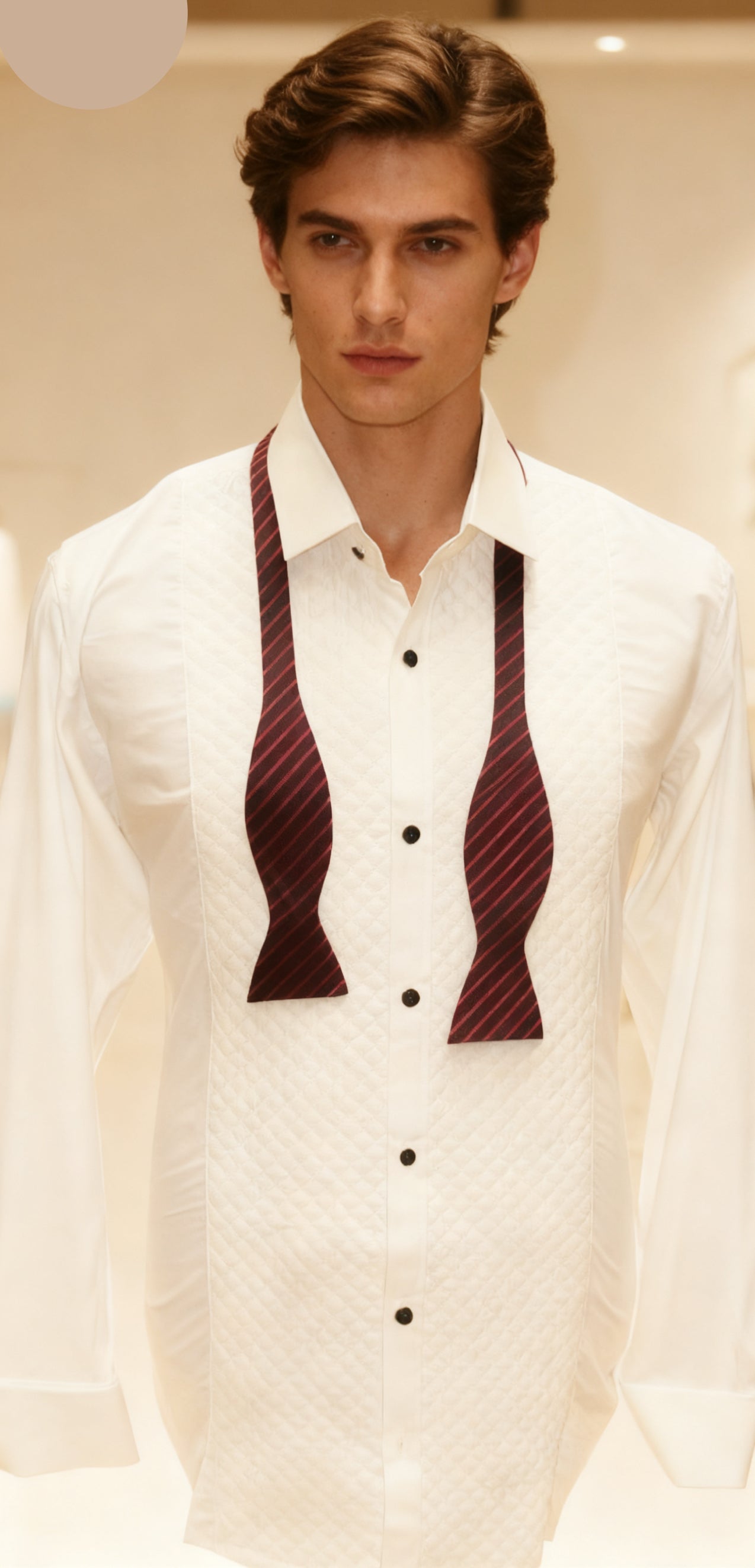 Man wearing a white shirt with patterned tie 