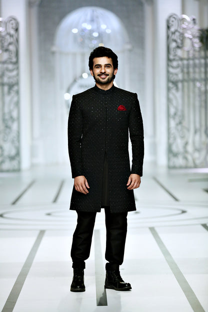 black sherwani with red kulla